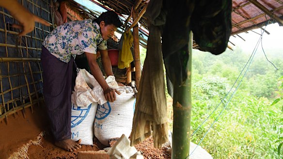 Nurullah works on reinforcing the rear of his family’s shelter on the edge of a cliff.
