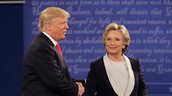Republican presidential nominee Donald Trump shakes hands with Democratic presidential nominee Hillary Clinton during the second presidential debate.