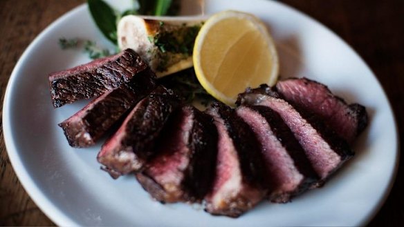 Steak served with bone marrow at upstairs steakhouse Longhorn Saloon.