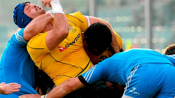 Wallabies skipper Nathan Sharpe is tackled by Martin Castrogiovanni.