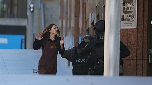 A Lindt cafe worker flees to safety.