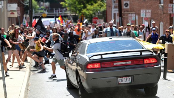 A vehicle drives into a group of protesters demonstrating against a white nationalist rally in Charlottesville.