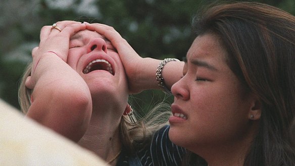 Students react at a triage area near Columbine High School in Littleton Colorado, during a shooting rampage by two students in 1999. 