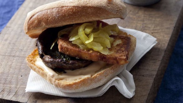 Mushroom burgers with haloumi, served with fried onion rings.