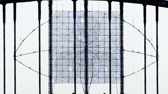 Blaze of light: Workers prepare the Harbour Bridge.