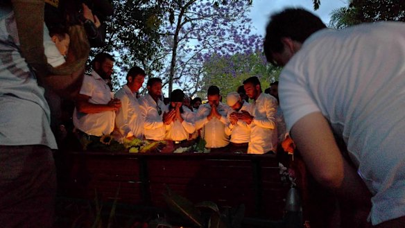 Members of the community mourn their colleague killed when an 'incendiary device' was allegedly thrown onto a bus in Moorooka.