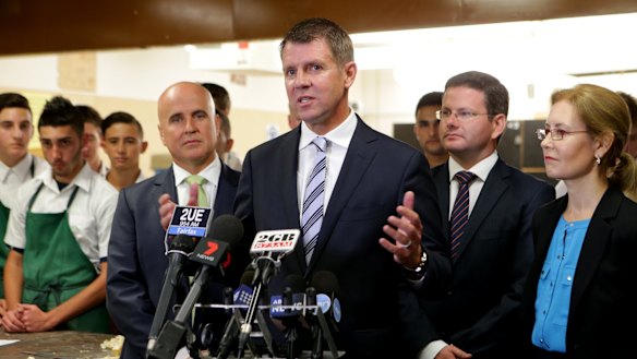 Mike Baird, flanked by ministers Adrian Piccoli and Gabriel Upton, says he expects Tony Abbott to prove wrong those who doubt him because of plummeting approval ratings.