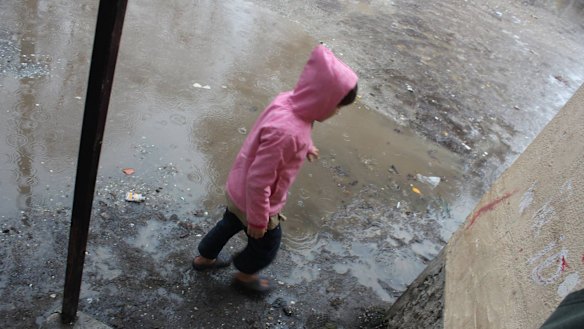 A child plays in the sodden Serres refugee camp in northern Greece. 