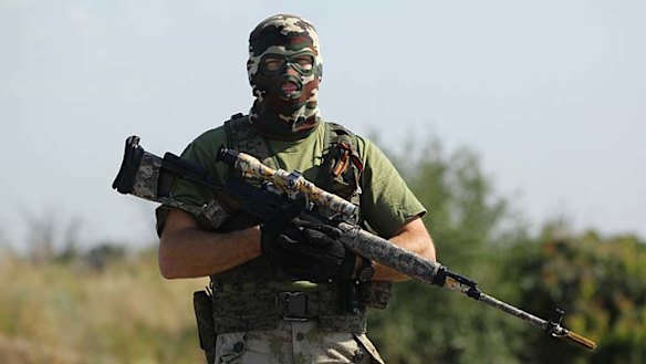 A pro-Russian rebel sniper, ''Angel'' stops vehicles at a checkpoint.
