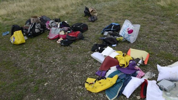 Passengers' belongings lie at the crash site of MH17. There has been multiple reports of looting.