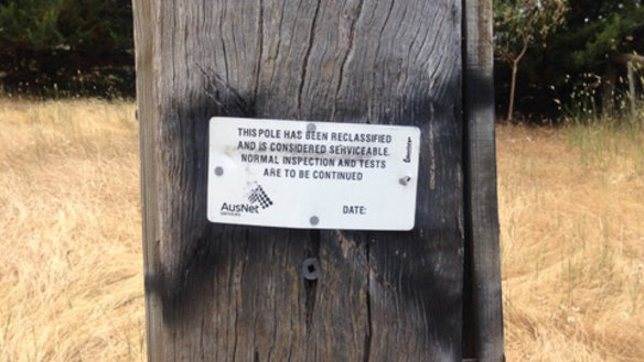 An example of a power pole that has been reclassified and temporarily left in service.