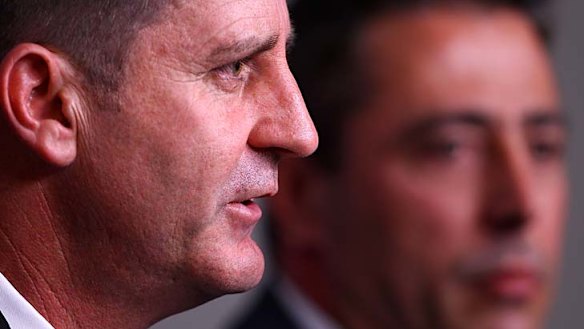 Ross Lyon addresses the media as Fremantle chief executive Steve Rosich looks on.