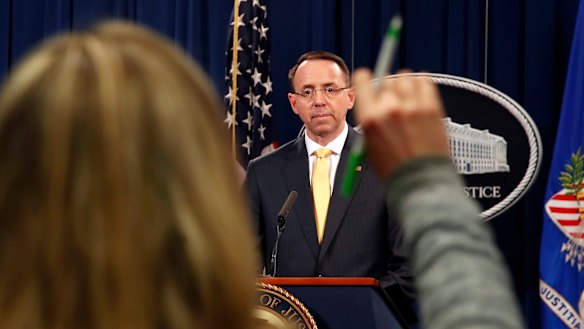 A reporter asks a question of  Deputy Attorney General Rod Rosenstein, after he announced that the office of special counsel Robert Mueller says a grand jury has charged 13 Russian nationals and several Russian entities.