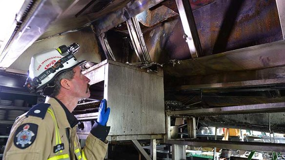 Fire station officer Damian O'Toole shows the kitchen extractor vent where the fire started.