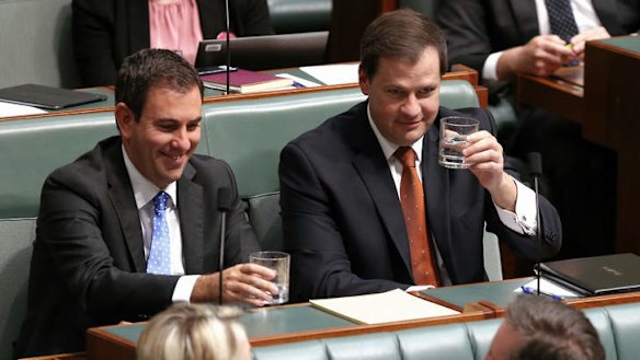 Labor MPs Jim Chalmers and Ed Husic clink glasses as Immigration Minister Scott Morrison rises to take the call during question time on Thursday.