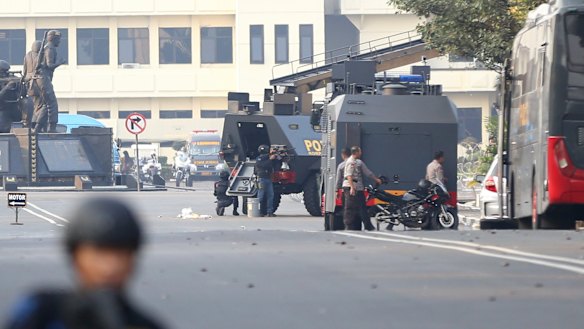 Officers guard the outside of a prison in Depok after prisoners staged a riot. 