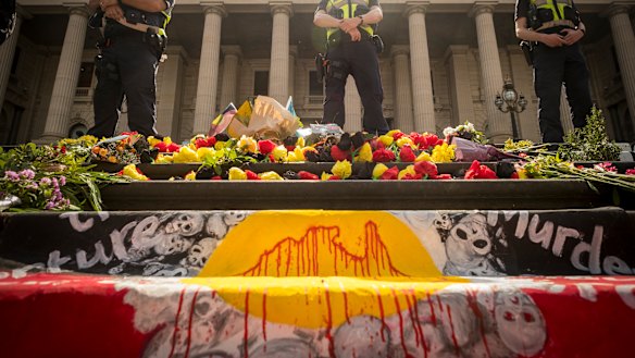 Police monitor the 'Invasion Day' rally.
