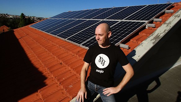 Darren Miller at home with his solar panels. 