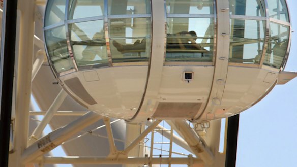 A couple gets amorous in one of the Southern Star's glass carriages last week. "I suppose it had to happen," said the observation wheel's chairman, Fred Maybury.