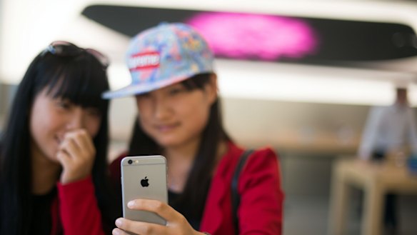 Checking out an iPhone 6 in an Apple store in Shanghai.