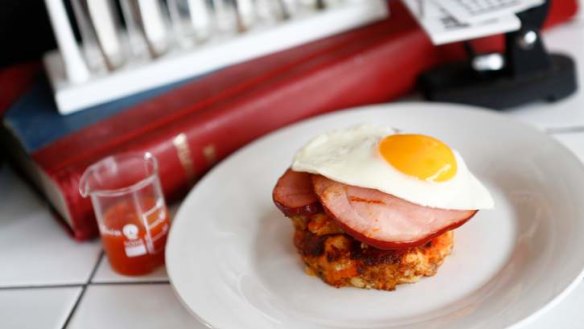 Bubble and squeak with carved ham and an egg sunny side up.