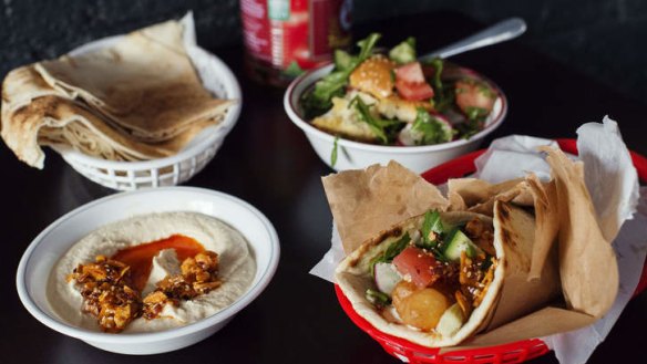 Fish kebab, village fattoush, spicy hummus and fried potato.