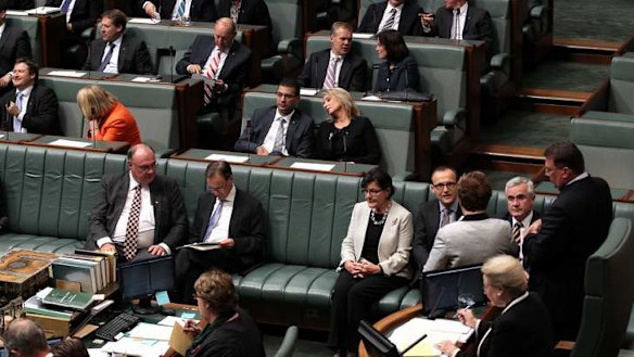 Greens MP Adam Bandt and Independent MPs Andrew Wilkie and Cathy McGowan move to vote with the Government during a division on the debt ceiling. Photo: Alex Ellinghausen