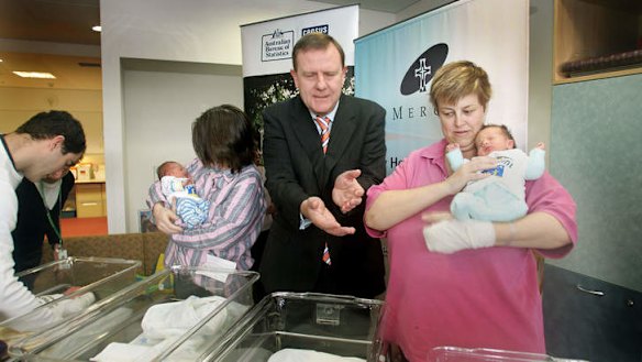 Then treasurer Peter Costello visiting babies born after he introduced the baby bonus scheme.