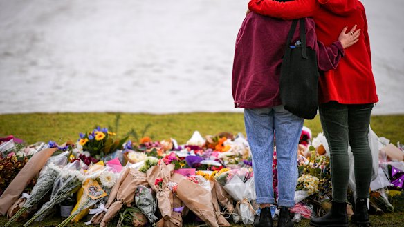 Mourners at the make shift memorial where Eurydice Dixon's body was found at the Princes Park, North Carlton.