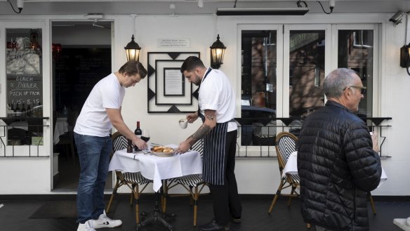 Chef Callum Brewin and waiter Gaetan Dossal preparing tables at MacLeay Street Bistro.