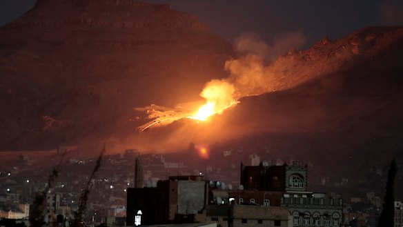 Fire and smoke rise after a Saudi-led air strike hit a site believed to be one of the largest weapons depots on the outskirts of Sanaa in October 2016.