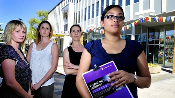 From left, Liz Henderson, of Watson, Linda Matthews, of Evatt, Linda Rosin, of Mawson, and Beth Price, of Queanbeyan, with the Protect Our Children petition outside the Legislative Assembly.