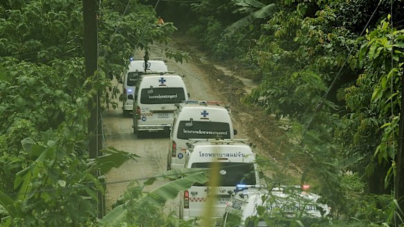 Five ambulances drive up the road leading to Tham Luang cave during the rescue operation. 