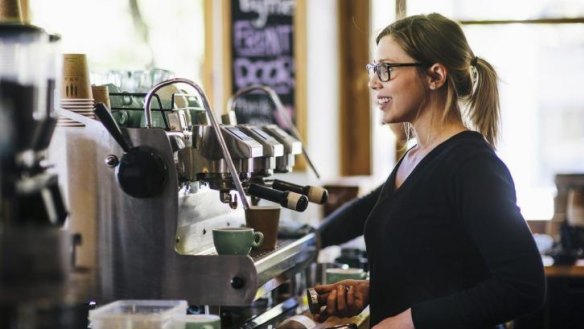 Caity Reynolds, head barista at The Cupping Room in Civic, serving customers.