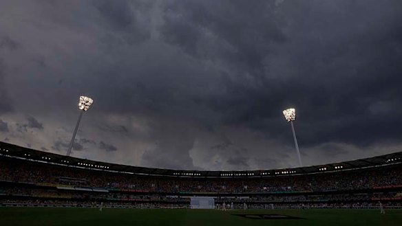 Storm clouds gather above the light towers during the fourth day's play at the Gabba.