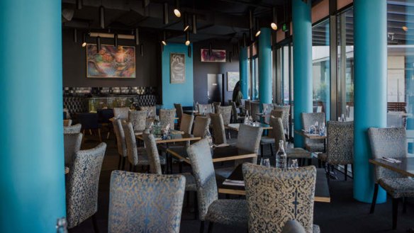 The C Dine dining room features pops of aqua blue.