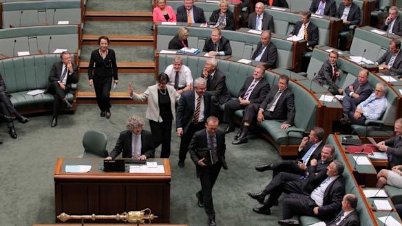 Greens MP Adam Bandt and Independent MPs Andrew Wilkie and Cathy McGowan move to vote with the Government during a division on the debt ceiling. Photo: Alex Ellinghausen
