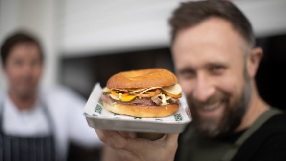 Comma Tuckshop owner Adam Cruickshank with a hanger steak bagel.  