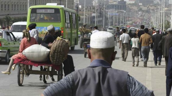 Road works ... carts, cars and buses head into Kashgar, Xinjiang.