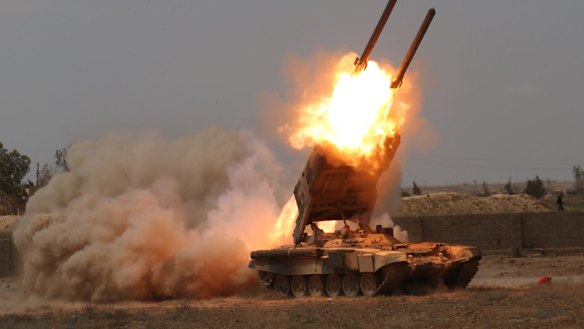 Iraqi security forces launch rockets against Islamic State extremist positions in Tikrit before taking the city.