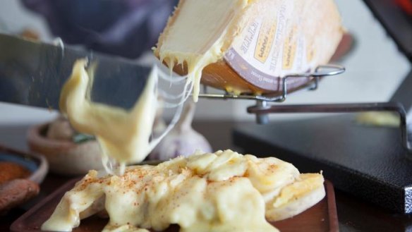 Cheese of your dreams: raclette being scraped over confit potatoes.