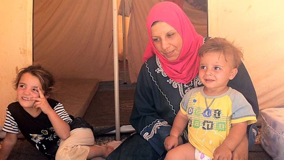''They were shooting directly at the children'' … Nasim Abu Ziad and two of her four children at the camp in Jordan.