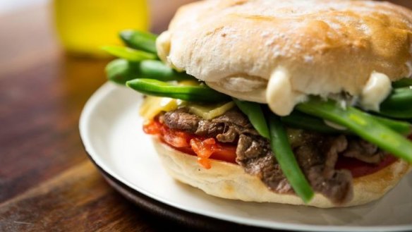 Chacarero sandwich with sliced beef, melted cheese, mayonnaise, tomato, green beans and green chilli.