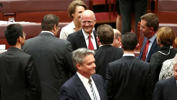 LDP Senator David Leyonhjelm is congratulated by PUP Senator Glenn Lazarus after delivering his maiden speech. Photo: Alex Ellinghausen
