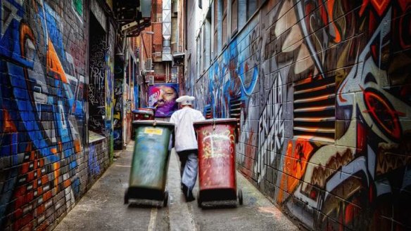 <i>Bin Duty</i>, by amateur photographer Alison Crea, shows a chef wheeling bins down Croft Alley, an inner-city Melbourne laneway.