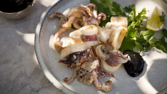 Fried calamari with fennel salt and black aioli makes a dramatic splash.
