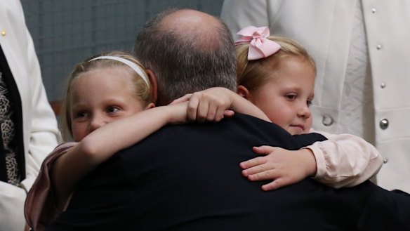 Treasurer Scott Morrison is hugged by his daughters, Lily and Abbey, after he gave the budget address on Tuesday.