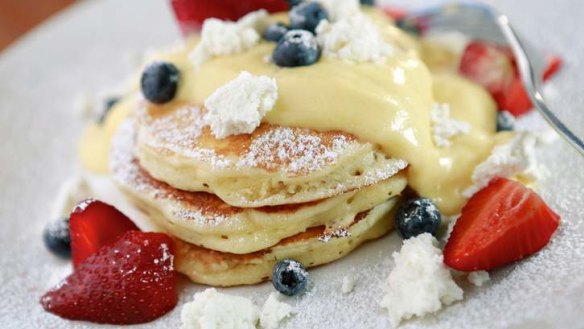 Sweet start: Fluffy hotcakes with passionfruit curd and fruit.