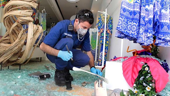 Probed ... police investigate the break-in at the Paddington boutique.