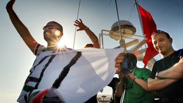 Activists on the Amal passenger boat wave farewell as they set sail from Aghios Nikolaos in Crete, Greece, to join the Free Gaza flotilla.